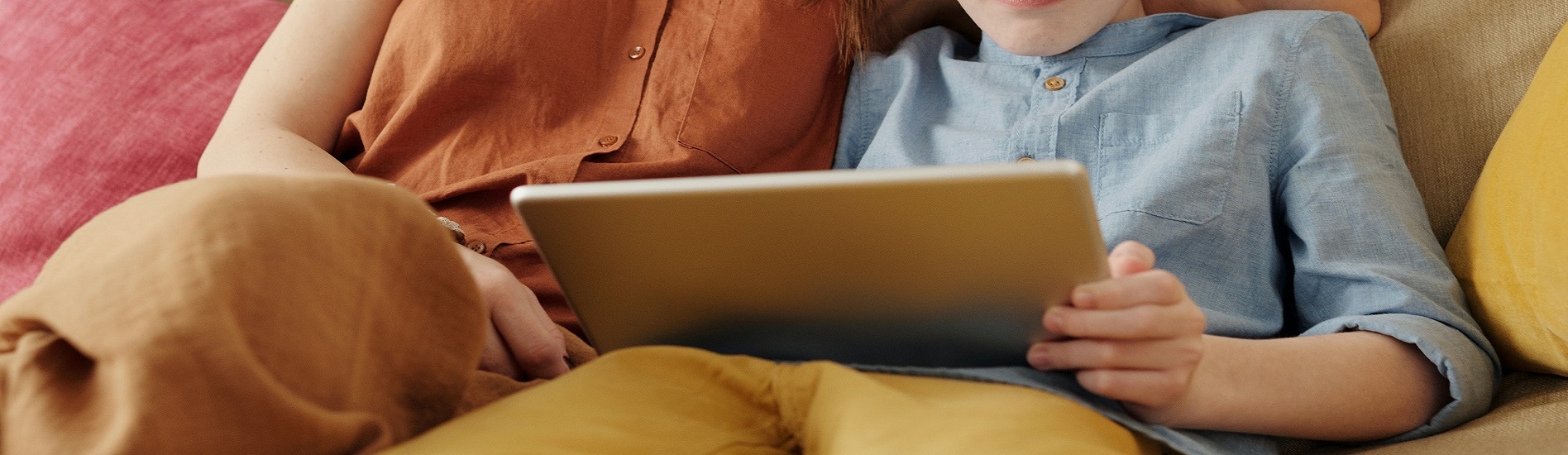 A parent and child looking at a laptop together